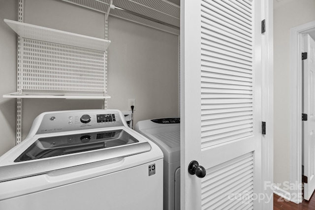 washroom featuring separate washer and dryer and laundry area