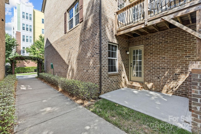 doorway to property featuring brick siding