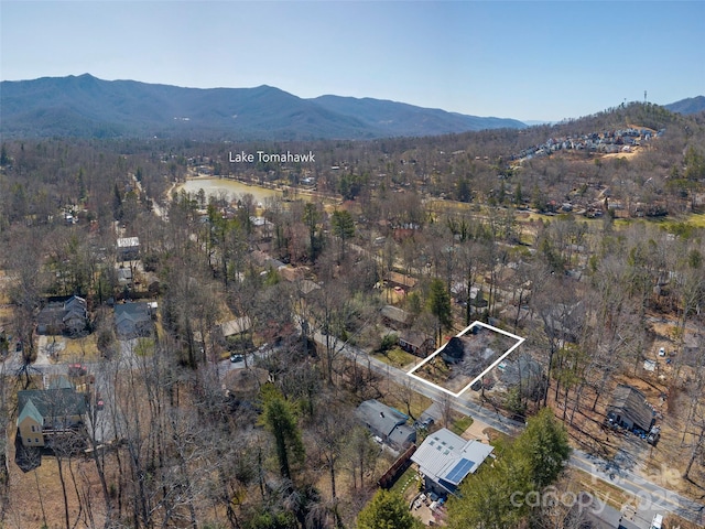 drone / aerial view with a wooded view and a mountain view