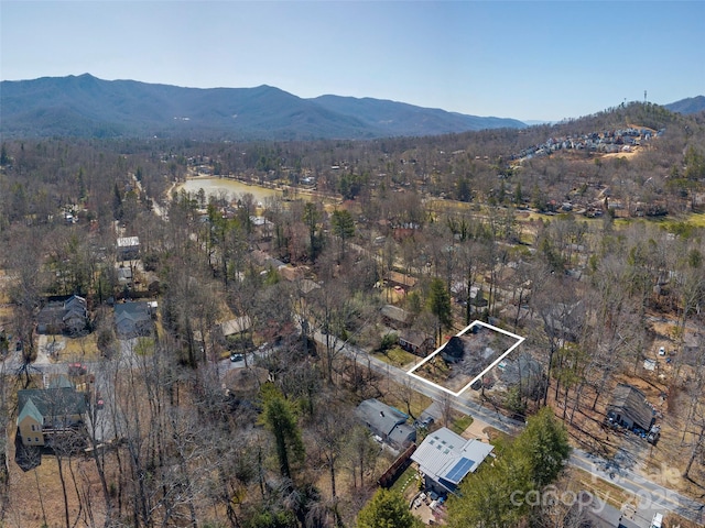 bird's eye view with a forest view and a water and mountain view