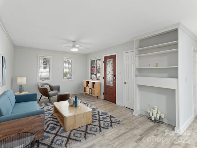 living area with a ceiling fan, baseboards, light wood finished floors, and ornamental molding