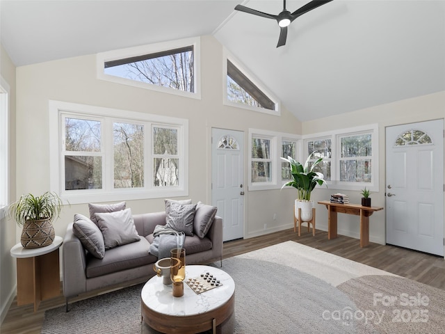 living room featuring baseboards, high vaulted ceiling, ceiling fan, and wood finished floors