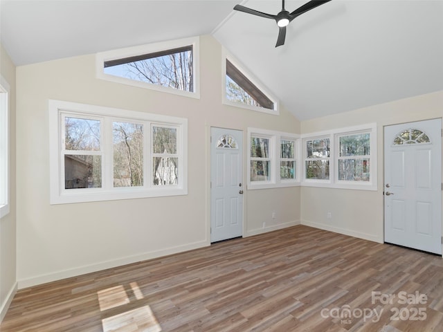 foyer with baseboards, wood finished floors, and a ceiling fan