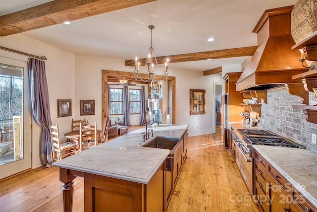 kitchen featuring tasteful backsplash, brown cabinets, light wood finished floors, and custom range hood