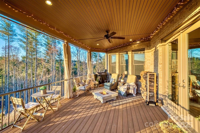 unfurnished sunroom with wooden ceiling, plenty of natural light, and ceiling fan