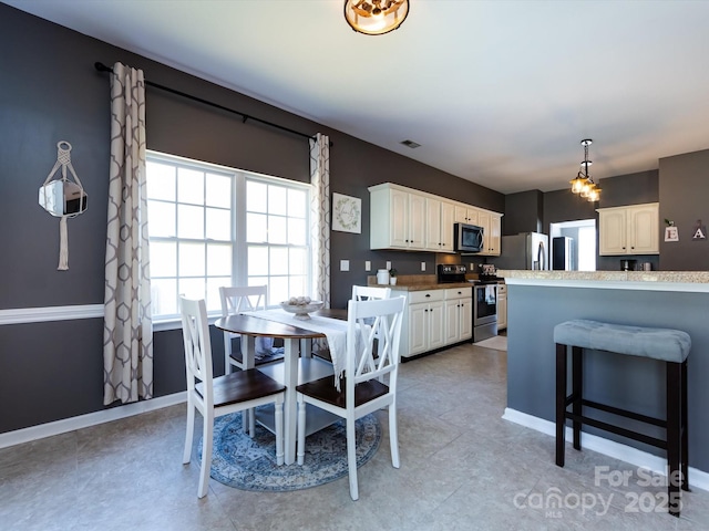 dining room featuring baseboards