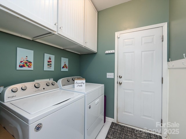 clothes washing area with cabinet space and separate washer and dryer