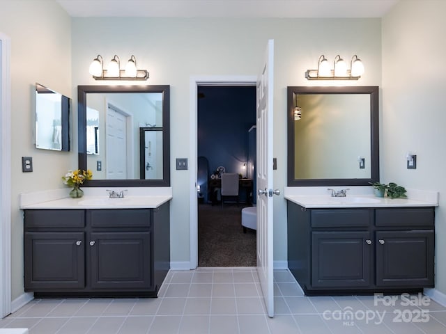 bathroom with tile patterned floors, two vanities, and a sink