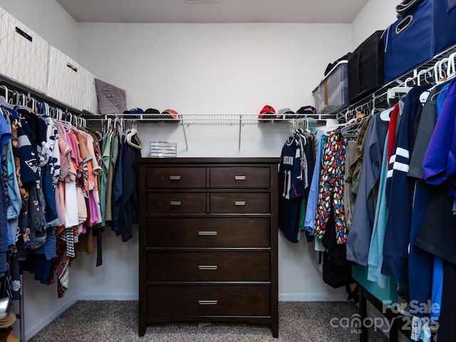 walk in closet with carpet floors