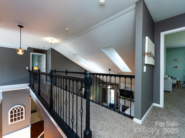 corridor featuring baseboards, lofted ceiling, an upstairs landing, and carpet flooring