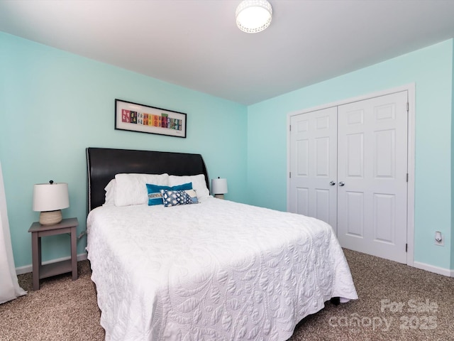 bedroom with a closet, baseboards, and carpet