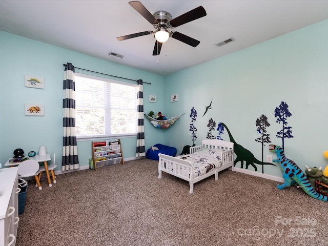 carpeted bedroom with a ceiling fan, baseboards, and visible vents