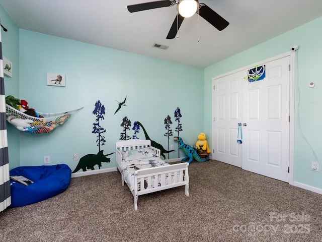 carpeted bedroom featuring visible vents, baseboards, and ceiling fan