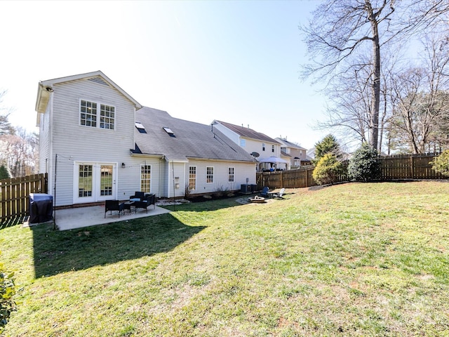 rear view of house featuring a patio area, a fenced backyard, and a lawn