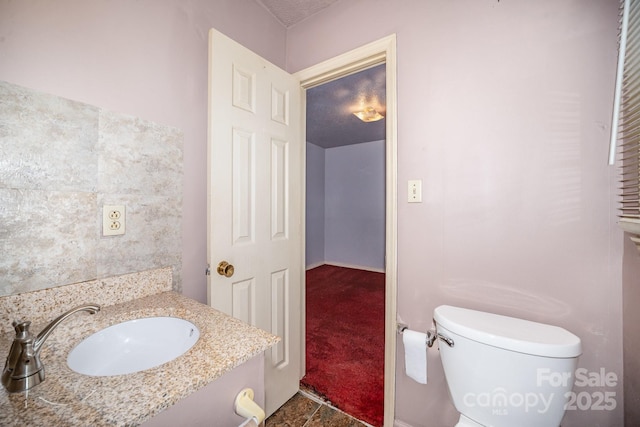 bathroom featuring toilet and vanity