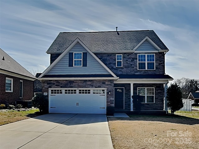 view of front of property featuring roof with shingles, concrete driveway, and a front lawn