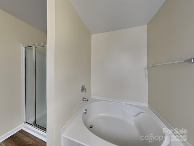 full bath featuring a garden tub and a stall shower