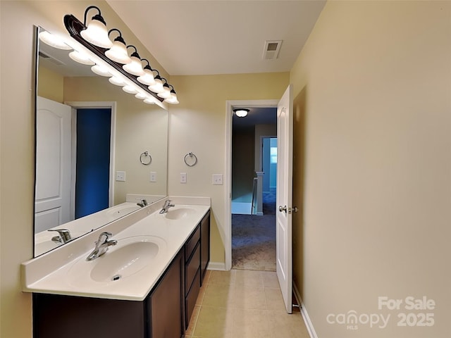 bathroom featuring tile patterned floors, visible vents, and a sink