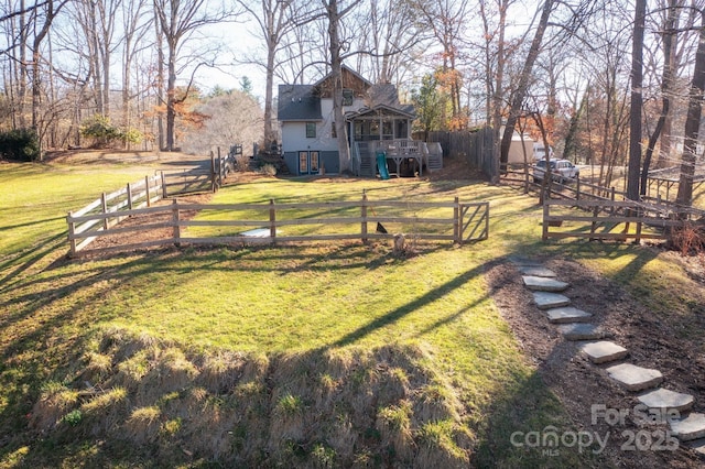 view of yard featuring a deck, stairway, and fence private yard