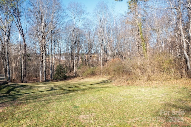 view of yard featuring a forest view