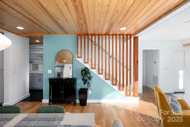 interior space with wooden ceiling and wood finished floors