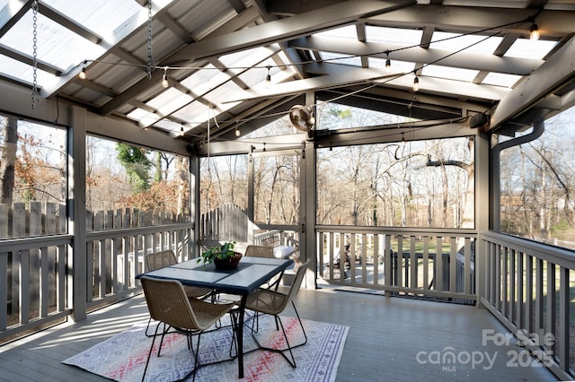 sunroom with vaulted ceiling with beams