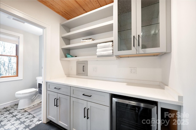 bar with wine cooler, wood ceiling, and visible vents