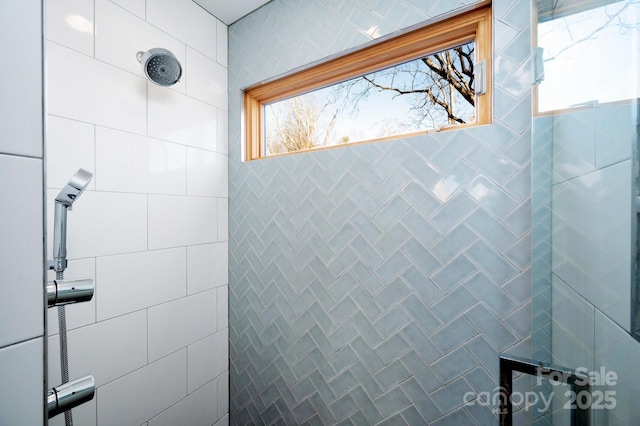 full bath with a tile shower