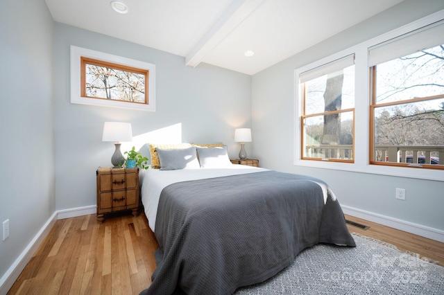 bedroom featuring beamed ceiling, visible vents, wood finished floors, recessed lighting, and baseboards