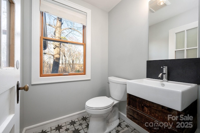 bathroom featuring tile patterned floors, toilet, vanity, and baseboards