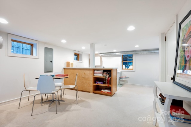 dining area featuring bar, electric panel, recessed lighting, and baseboards