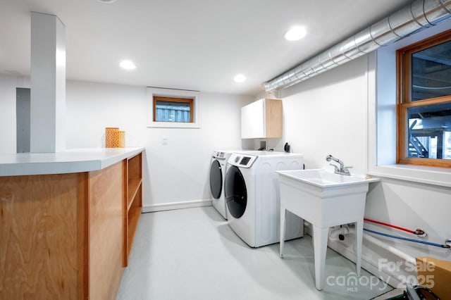 washroom featuring recessed lighting, cabinet space, baseboards, and washer and clothes dryer