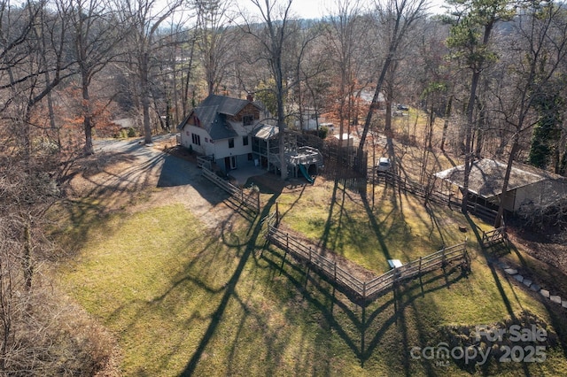 bird's eye view with a wooded view