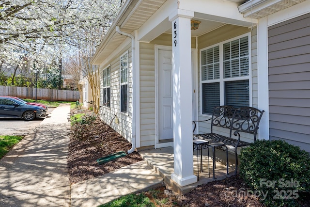 exterior space with covered porch and fence