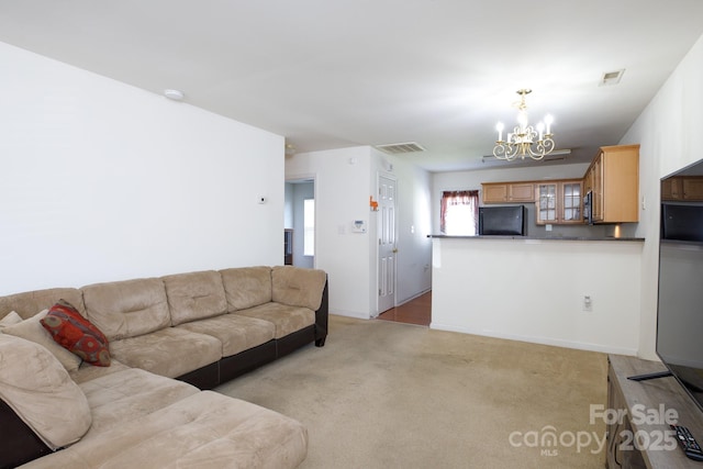 living area featuring light colored carpet, visible vents, and a chandelier