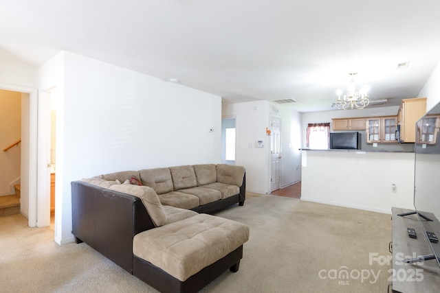 living room featuring visible vents, light carpet, a chandelier, and stairs