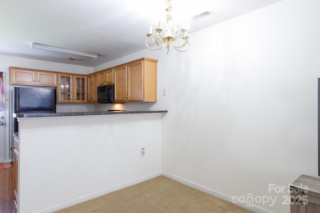 kitchen featuring carpet, baseboards, glass insert cabinets, black microwave, and dark countertops