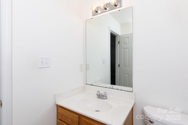 bathroom with toilet and vanity