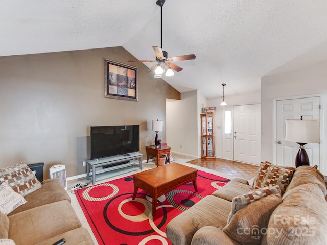 living area featuring lofted ceiling, a ceiling fan, baseboards, and a textured ceiling