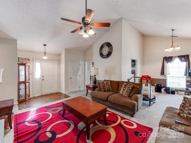 carpeted living area with ceiling fan, high vaulted ceiling, and a textured ceiling