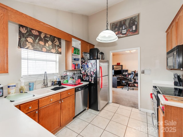 kitchen featuring light tile patterned floors, brown cabinetry, stainless steel appliances, and light countertops