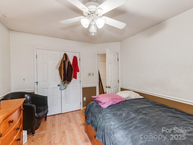 bedroom featuring a closet, ceiling fan, and wood finished floors