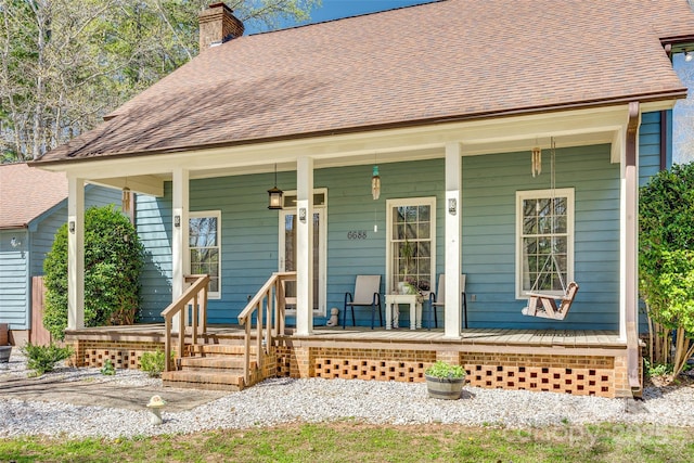 6688 Pine Forest Dr, York, SC 29745 - view of front of house featuring a chimney, covered porch, and roof with shingles