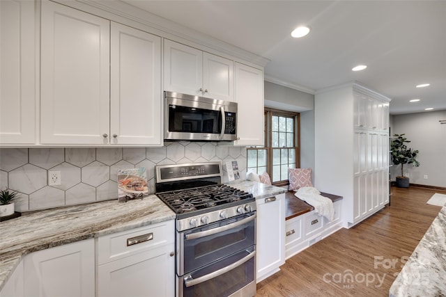 6688 Pine Forest Dr, York, SC 29745 - kitchen featuring appliances with stainless steel finishes, white cabinetry, light wood-style floors, recessed lighting, and crown molding