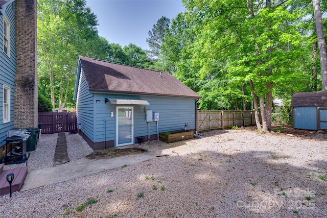 6688 Pine Forest Dr, York, SC 29745 - view of front of property with a fenced backyard, a shed, a shingled roof, and an outdoor structure