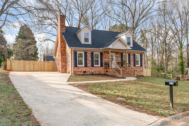 new england style home featuring crawl space, fence, brick siding, and roof with shingles