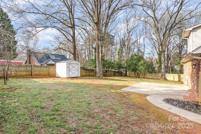 view of yard featuring an outbuilding, a storage shed, and a fenced backyard