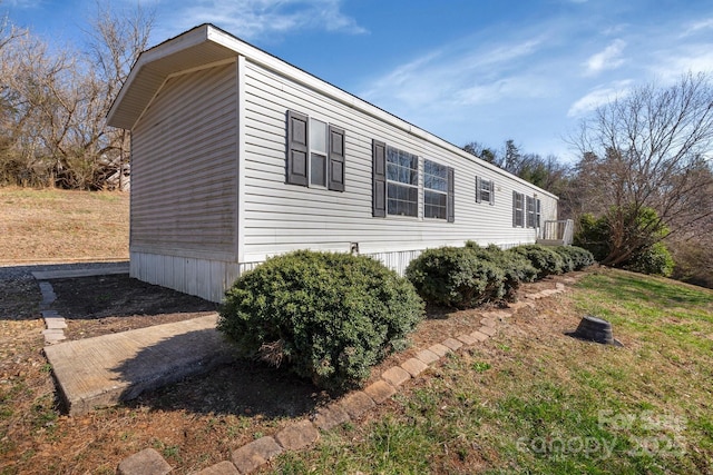 view of side of home featuring a lawn