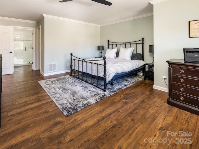 bedroom with dark wood finished floors, visible vents, and crown molding