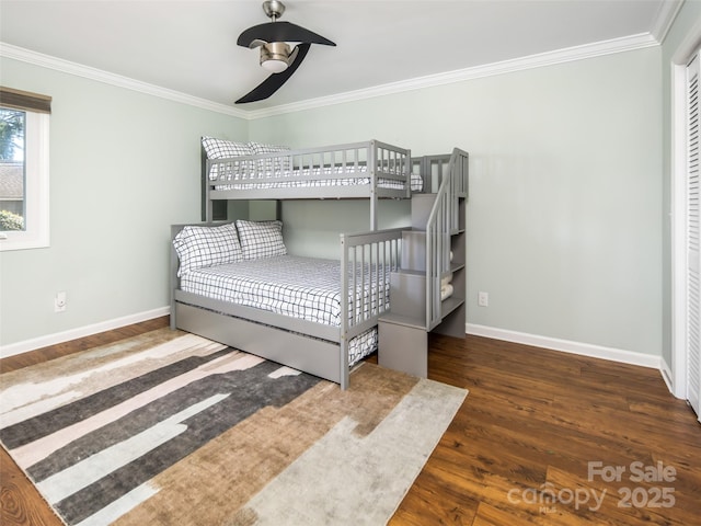 bedroom featuring ceiling fan, baseboards, wood finished floors, and crown molding